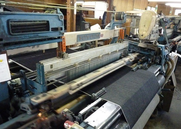A Toyoda shuttle loom. Note the narrow width of the fabric.