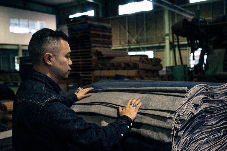 Johan Lam surveying a custom run of 3sixteen fabric at Kuroki Mills in Japan.