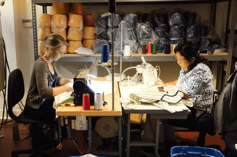 Workers sewing in Ebbets Field Flannel's Seattle workshop.