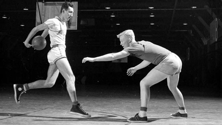 Chuck Taylor on the court in a pair of his eponymous shoes.