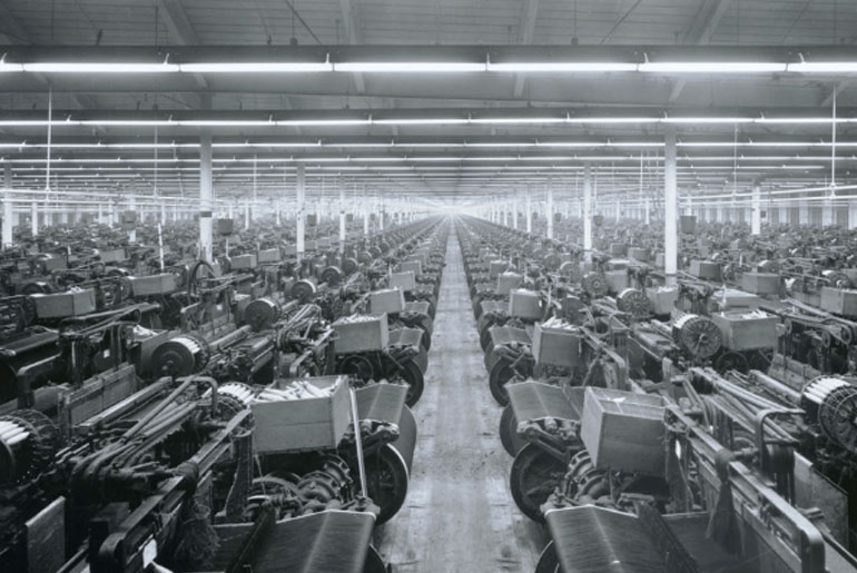 An old photo from inside Cone Mills's White Oak Plant, the last selvedge denim manufacturer in the United States.