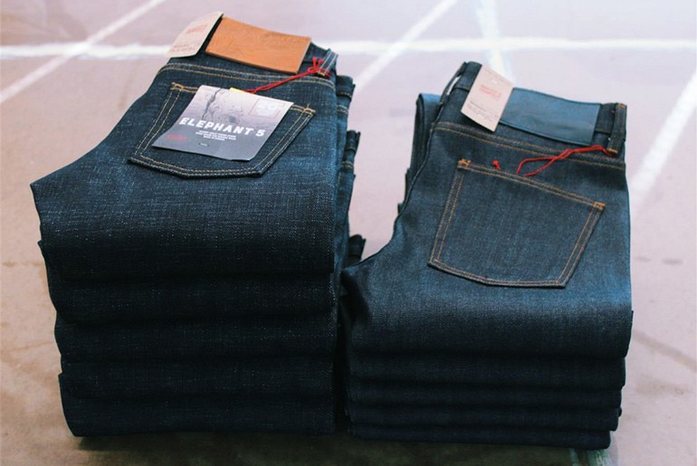 Five pairs of the Ele 5 stacked next to five pairs of midweight denim jeans.