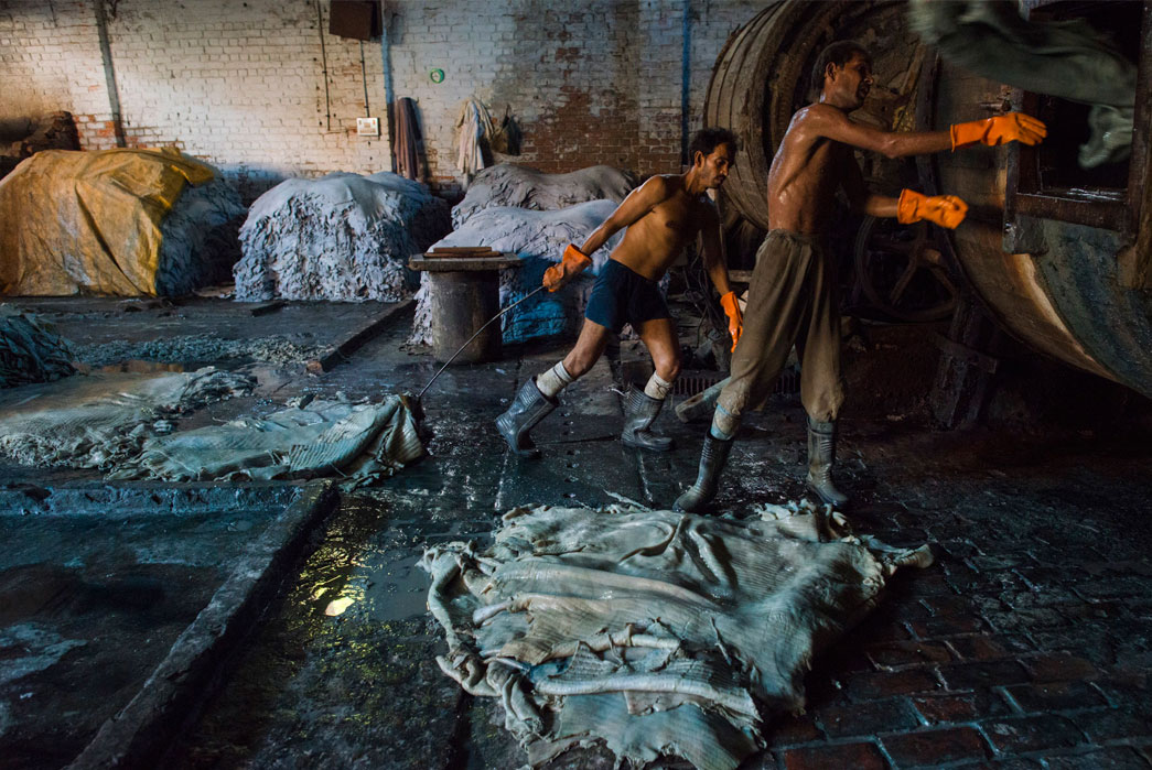 A leather tannery in Kanpur, India where workers treat buffalo leather hides with lye and chromium. Image via nationalgeographic.com
