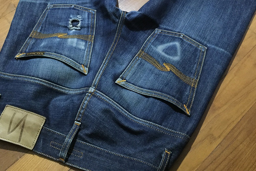 Fade-of-the-Day---Nudie-Jeans-Thin-Finn-(7-Months,-1-Wash,-1-Soak)-back-top-on-floor