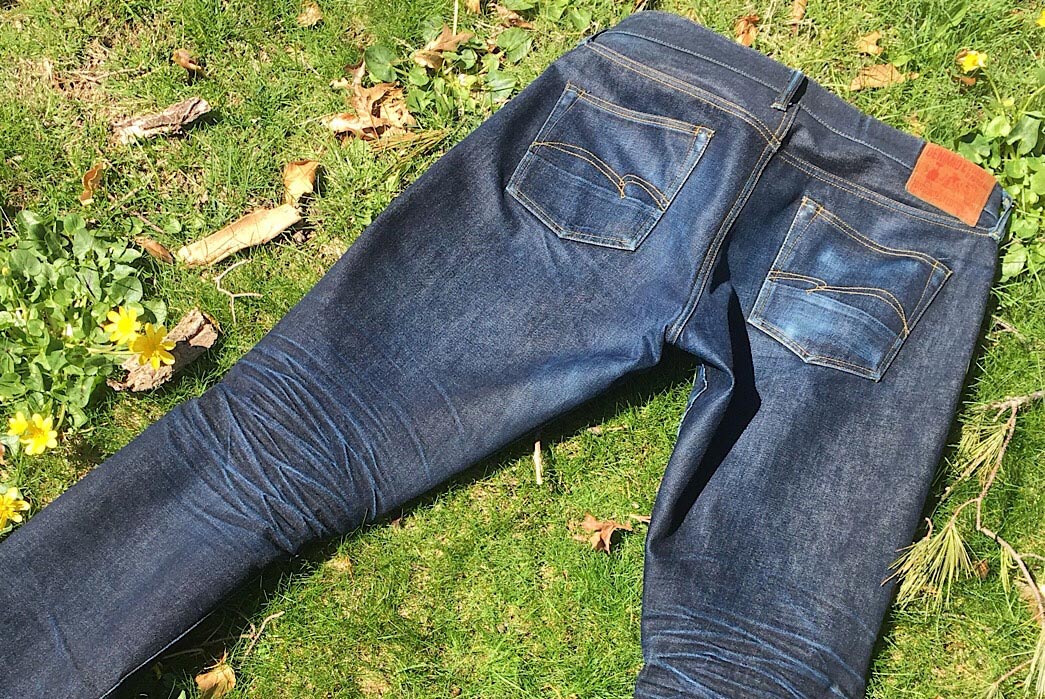 Fade-of-the-Day---Studio-D'artisan-x-Denimio-DM-002-(6-Months,-1-Wash,-1-Soak)-back on grass