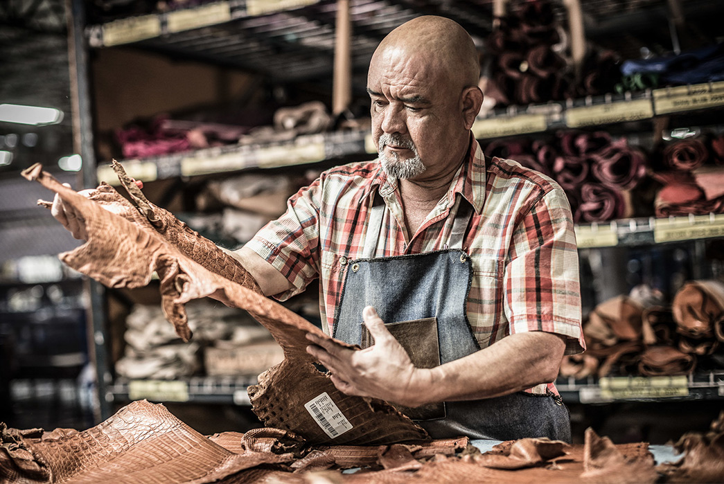 Sicily-to-San-Antonio-The-Story-of-Lucchese-Boots-Bootmaker-inspects-leather.-Image-via-The-American-Craftsman-Project.