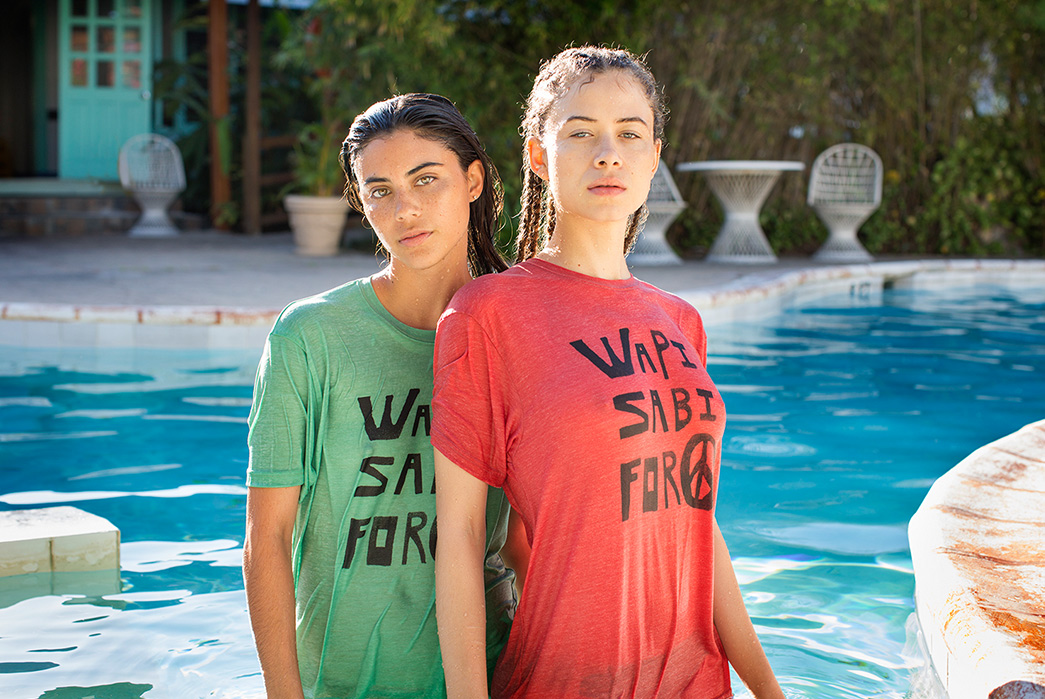 Kapital's-Yardie-Blues-Lookbook-Meanders-Through-Jamaica-and-Misadventure-two-females-one-in-red-and-second-in-green-2