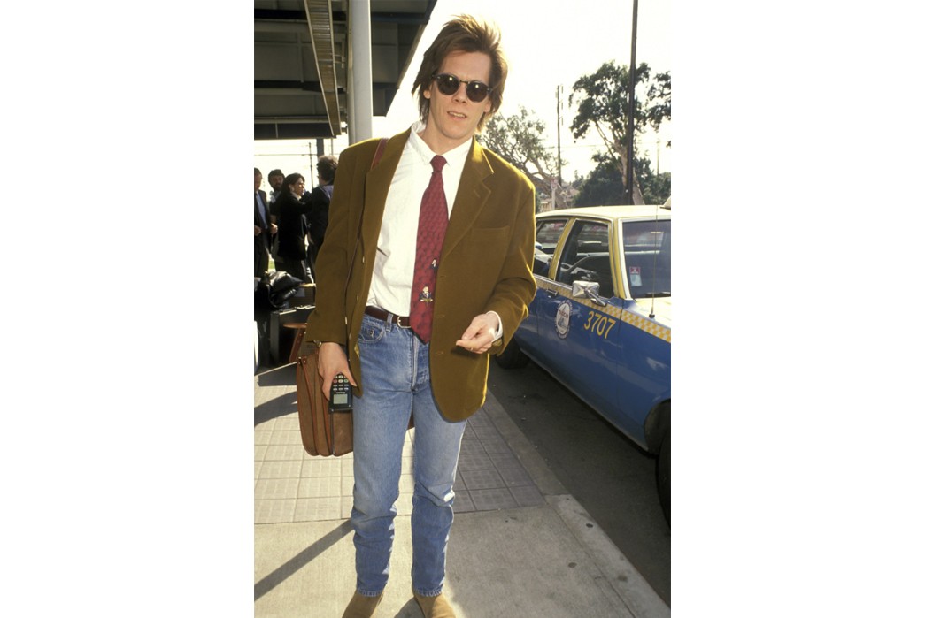 Blazers-Not-Just-For-Nerds Kevin Bacon in the 90s at LAX. Image via GQ.