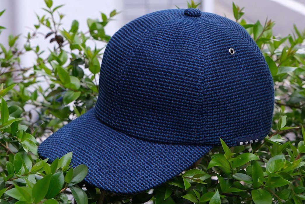 Okayama-Denim-Collabs-With-The-Factory-Made-For-An-Indigo-Drenched-Ball-Cap-side-on-foliage