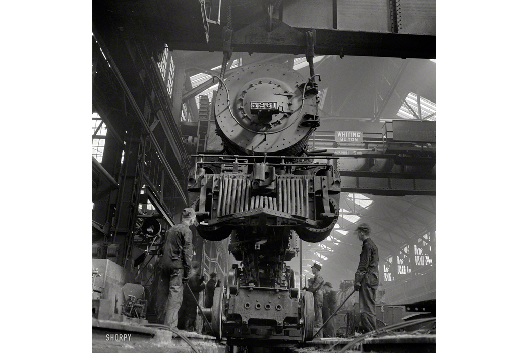 Beyond-The-Tracks---How-Railroading-Impacted-American-Workwear-Pt.-2-Shopmen-working-on-a-locomotive-in-Kansas-as-captured-by-Delano-from-the-pit,-1943.-Image-via-Jack-Delano-Shorpy.com.