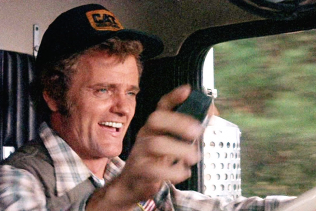 Trucker-Hats-(Title-TBC)-Jerry-Reed-as-Cledus-aka-Snowman-wearing-a-CAT-promotional-hat-in-the-1977-film-Smokey-and-the-Bandit.-Image-via-Universal-Pictures.