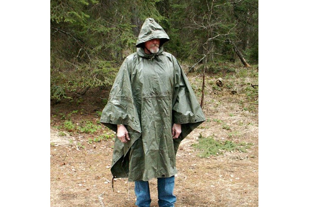 How-to-Get-Into-Camping-Part-3-Garb-and-Grappling-With-Nature-Demonstrating-a-military-surplus-rain-poncho.-Image-via-Etsy-Pinterest.