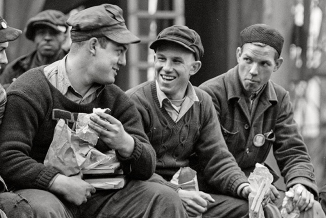 The-History-of-Varsity-Jackets-Arthur-Siegel-captured-this-photo-of-shipyard-workers-taking-lunch-in-1943.-The-guy-third-from-the-right-appears-to-have-a-varsity-letter-on-his-sweater..