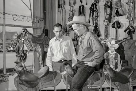 The-History-of-Snap-Buttons-Featured-image.-Arthur-Rothstein-captured-this-cowboy-trying-on-a-saddle-in-Elko,-Nevada.-1940.-Open-pockets-reveal-the-use-of-snaps.-Image-via-Shorpy.com.