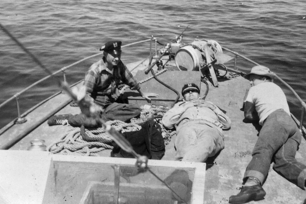 Alaskan-Odyssey-Fishing-Fleet-Workwear,-Part-I-Fishermen-rest-on-the-deck-of-the-boat-after-a-long-day.-Note-the-caps.-Image-via-mhallack-Shorpy.com.